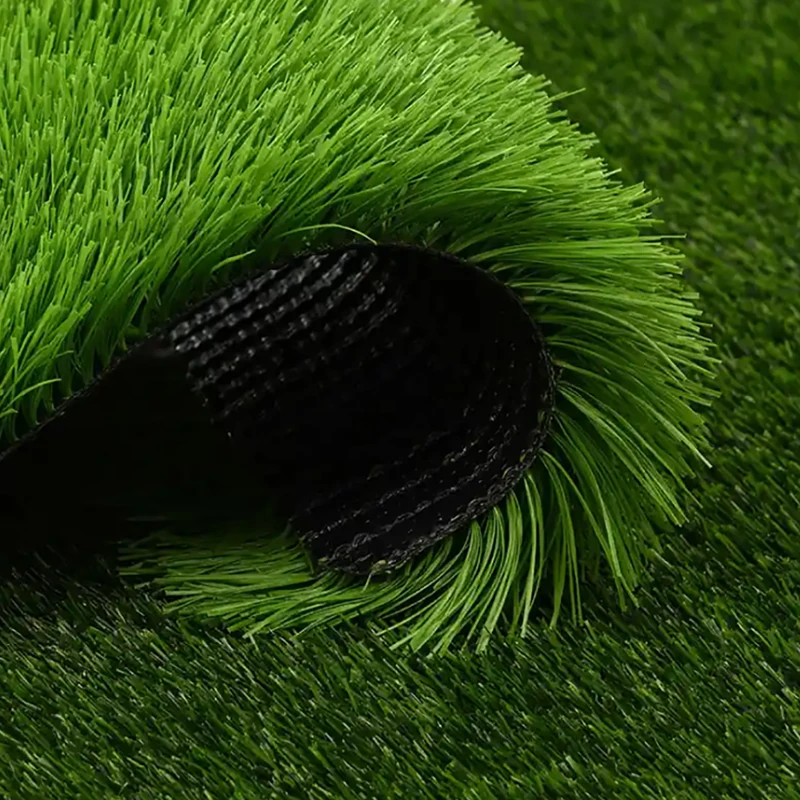 Close-up sample of high-density outdoor artificial turf for football fields showing durable black backing and vibrant green 50mm fibers banner