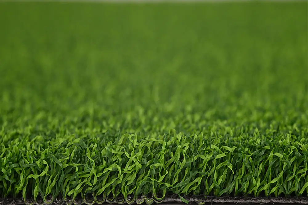 Side view of dense 16mm curly grass fibers of X-Nature Grass 7016 playground turf
