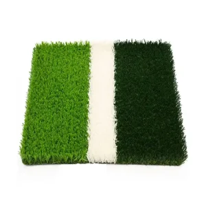 close up of artificial football turf showing green grass fibers and a white field marking strip.(1)