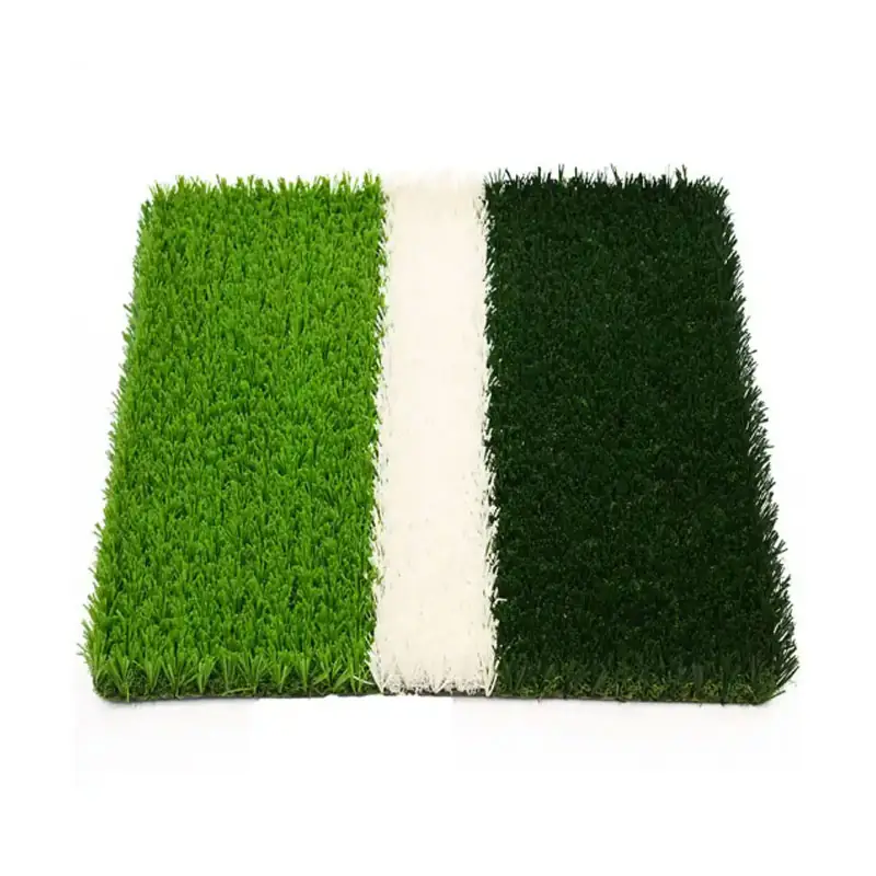 close up of artificial football turf showing green grass fibers and a white field marking strip.(1)